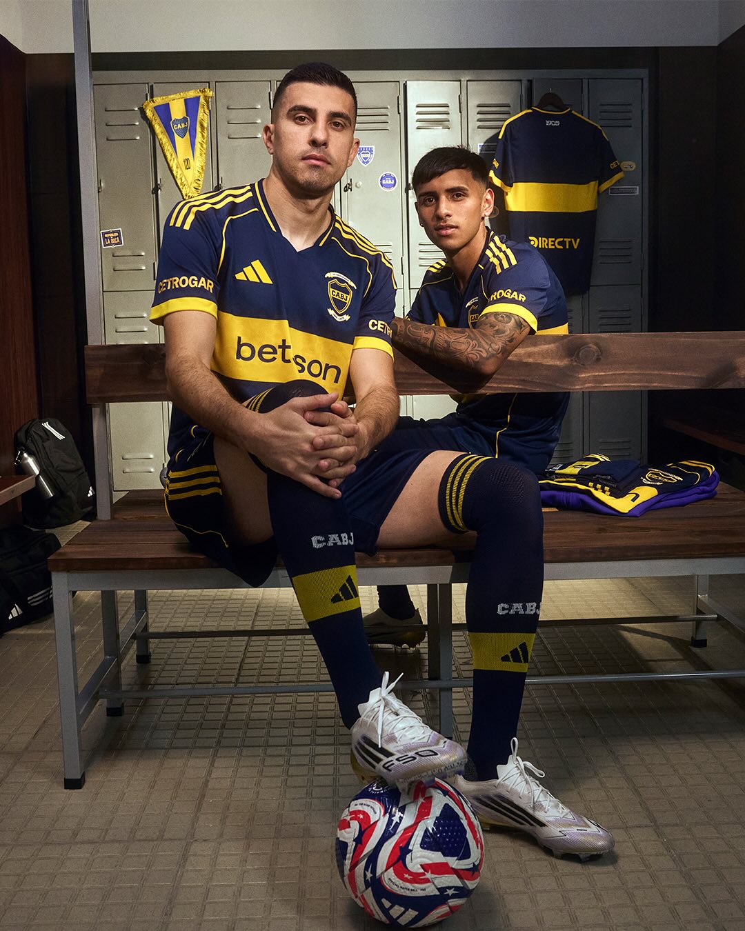 Ezequiel Zeballos and Rodrigo Battaglia wearing Boca Juniors 2025-2026 home kit