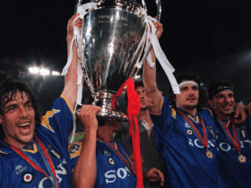 Juventus players lifting the UEFA Champions League trophy wearing the Juventus 1995-1996 away kit