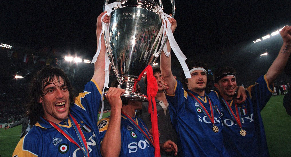 Juventus players lifting the UEFA Champions League trophy wearing the Juventus 1995-1996 away kit