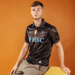 Sam Beukema wearing the Napoli 2025-2026 Home Kit looking in the camera