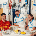 Olympique de Marseille players eating with the Olympique de Marseille 2025-2026 home kit
