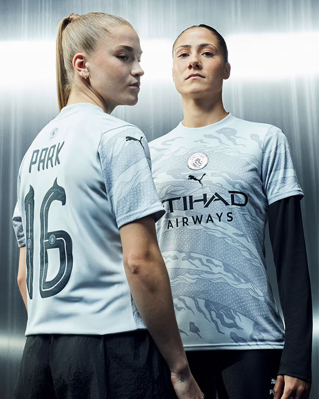 Two women Manchester City players wearing Manchester City 2024 Special Kit