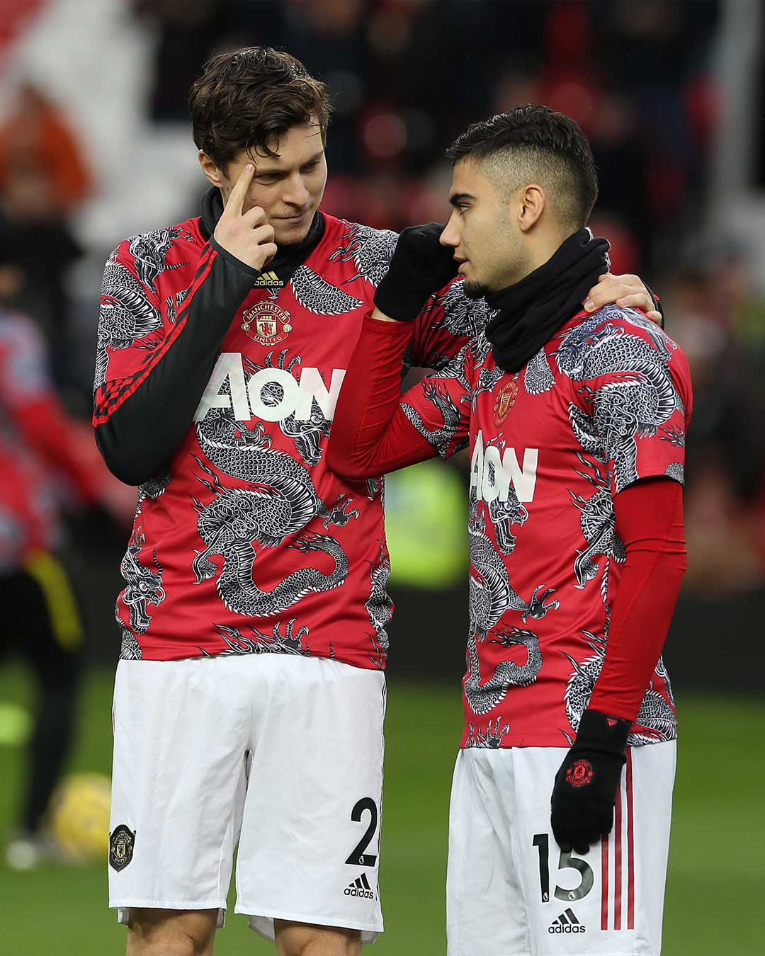Two Manchester United players wearing Manchester United chinese year warm up kit