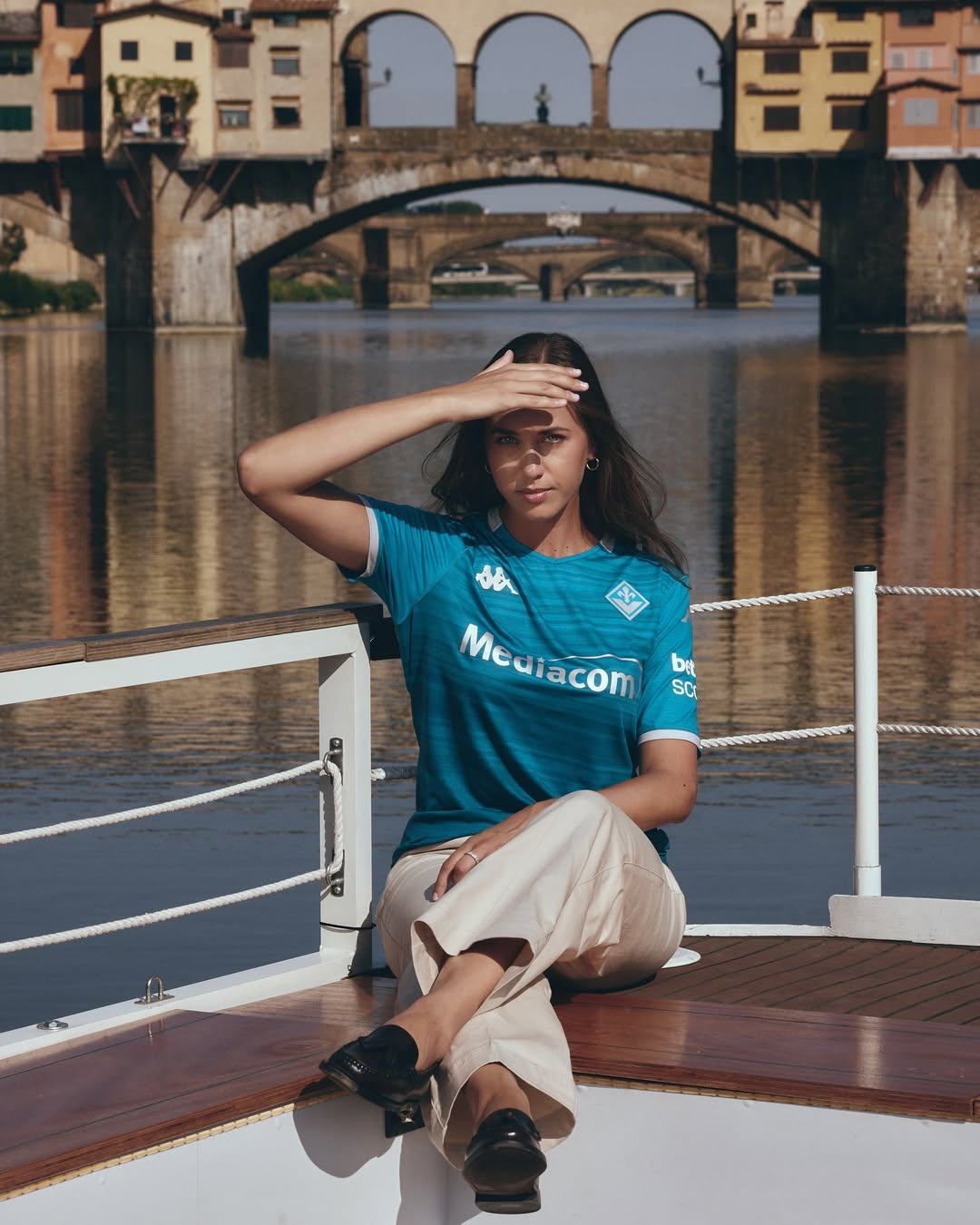 A woman wearing Fiorentina 2025-2026 third kit