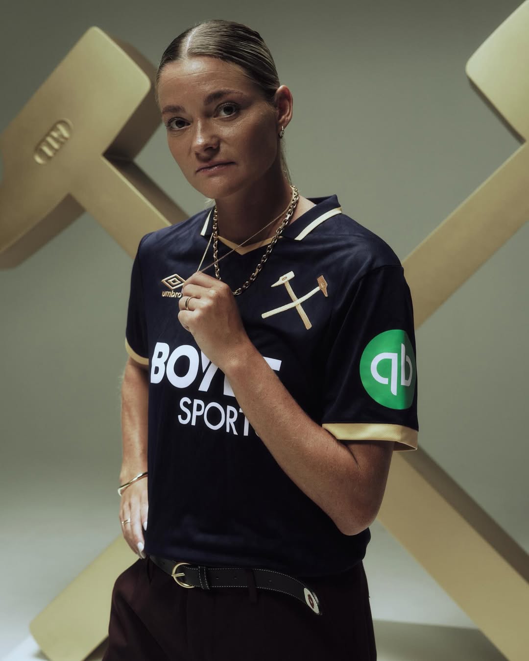 A woman wearing West Ham 2025-2026 third kit