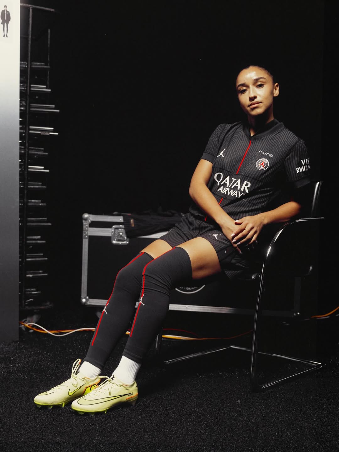 A woman wearing Paris Saint Germain 2025-2026 fourth kit