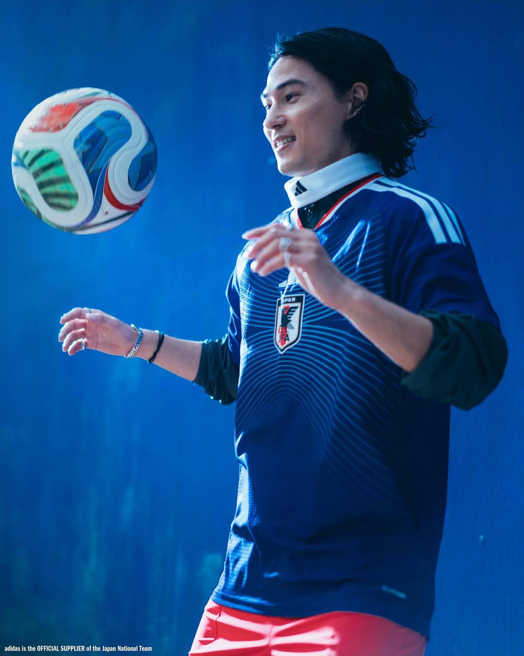Takumi Minamino wearing Japan World Cup 2026 home kit